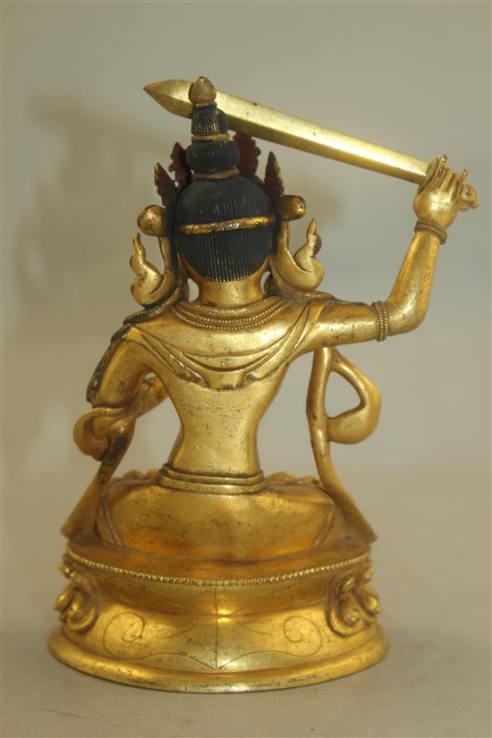 A Tibetan gilt bronze figure of Manjushri, 18cm